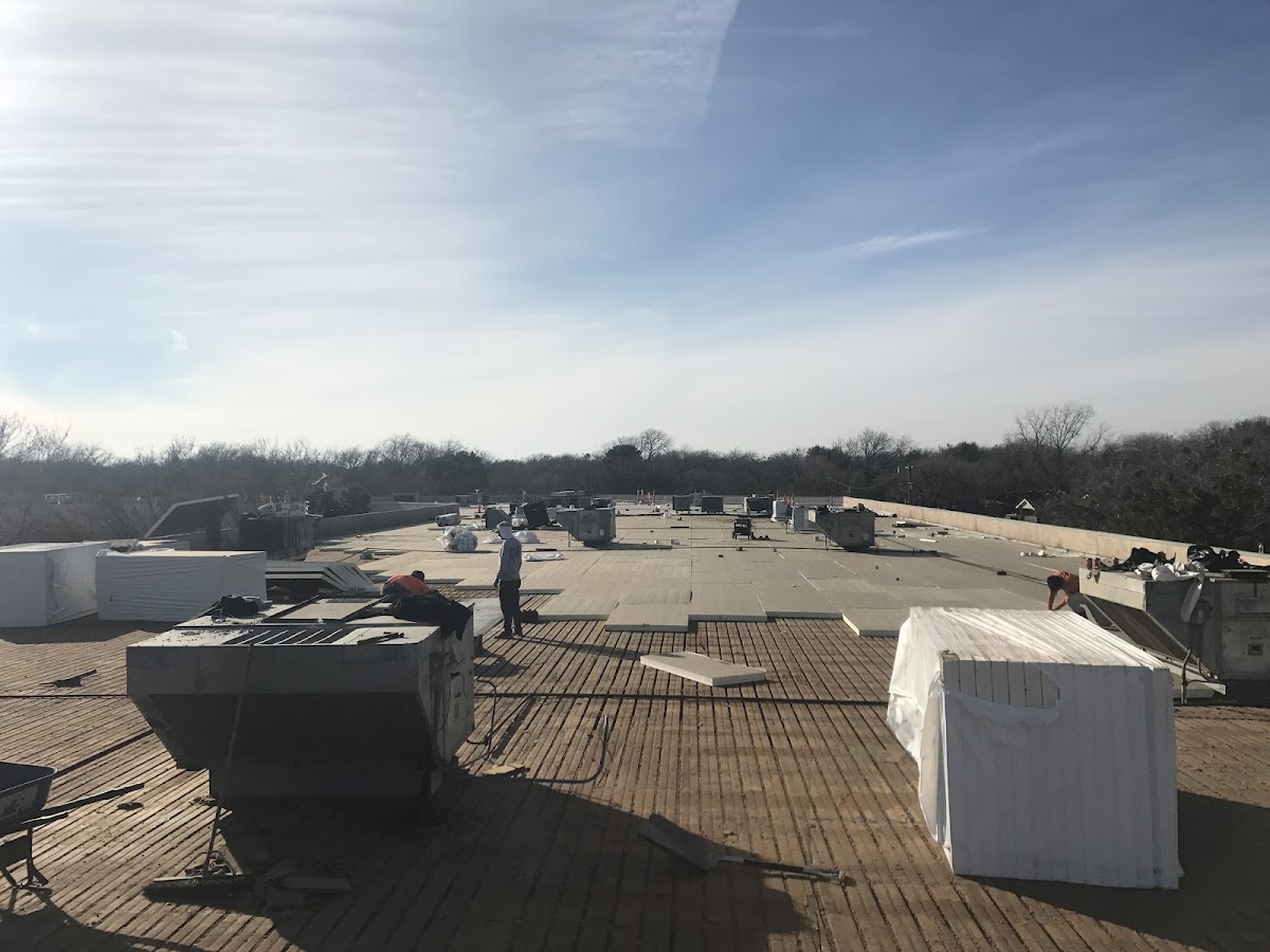 Boatman crew working on a large commercial flat roof in Abilene