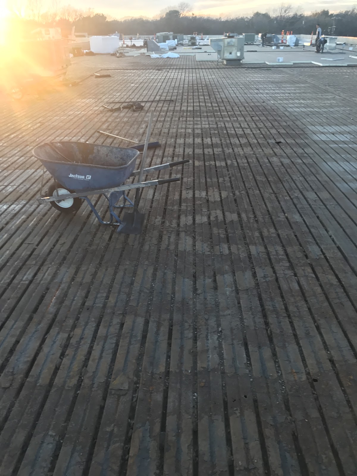 Commercial flat roof at golden hour after Boatman Roofing repair